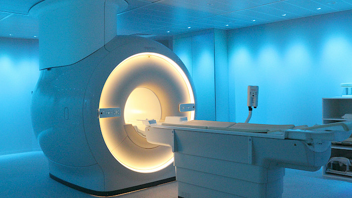 Medical imaging examination using a CT scanner in a radiology department.