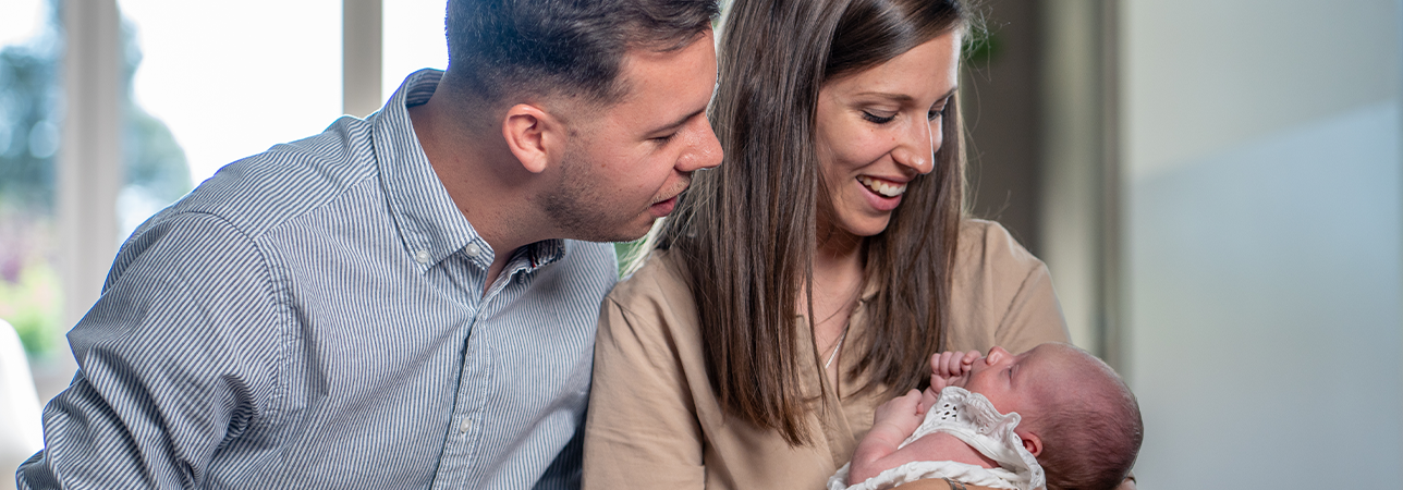 Parents holding a newborn baby